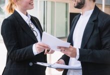 businessman-businesswoman-holding-documents-hands_23-2147972825-5951448